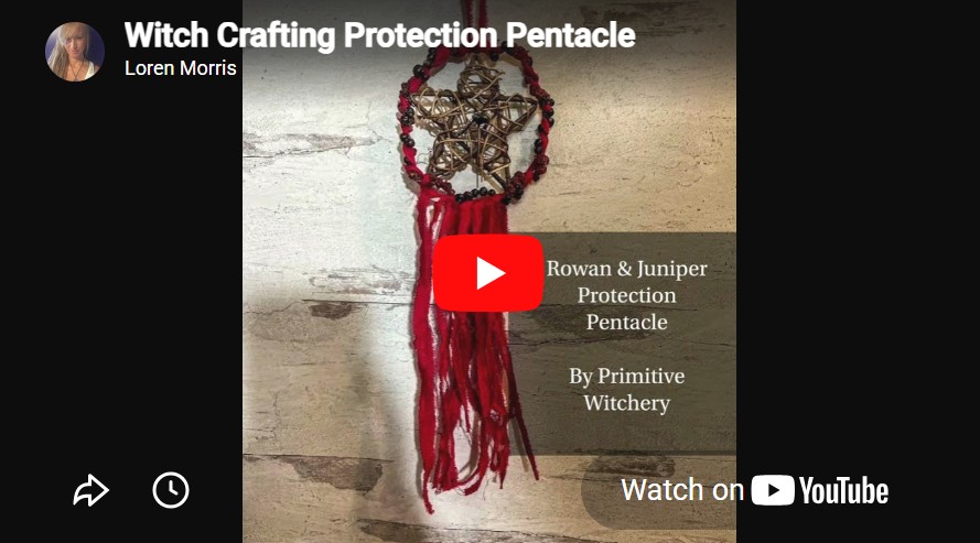 Handcrafted Rowan and Juniper Berry Protection Pentacle with red yarn fringe and dark berry beads on a woven star frame